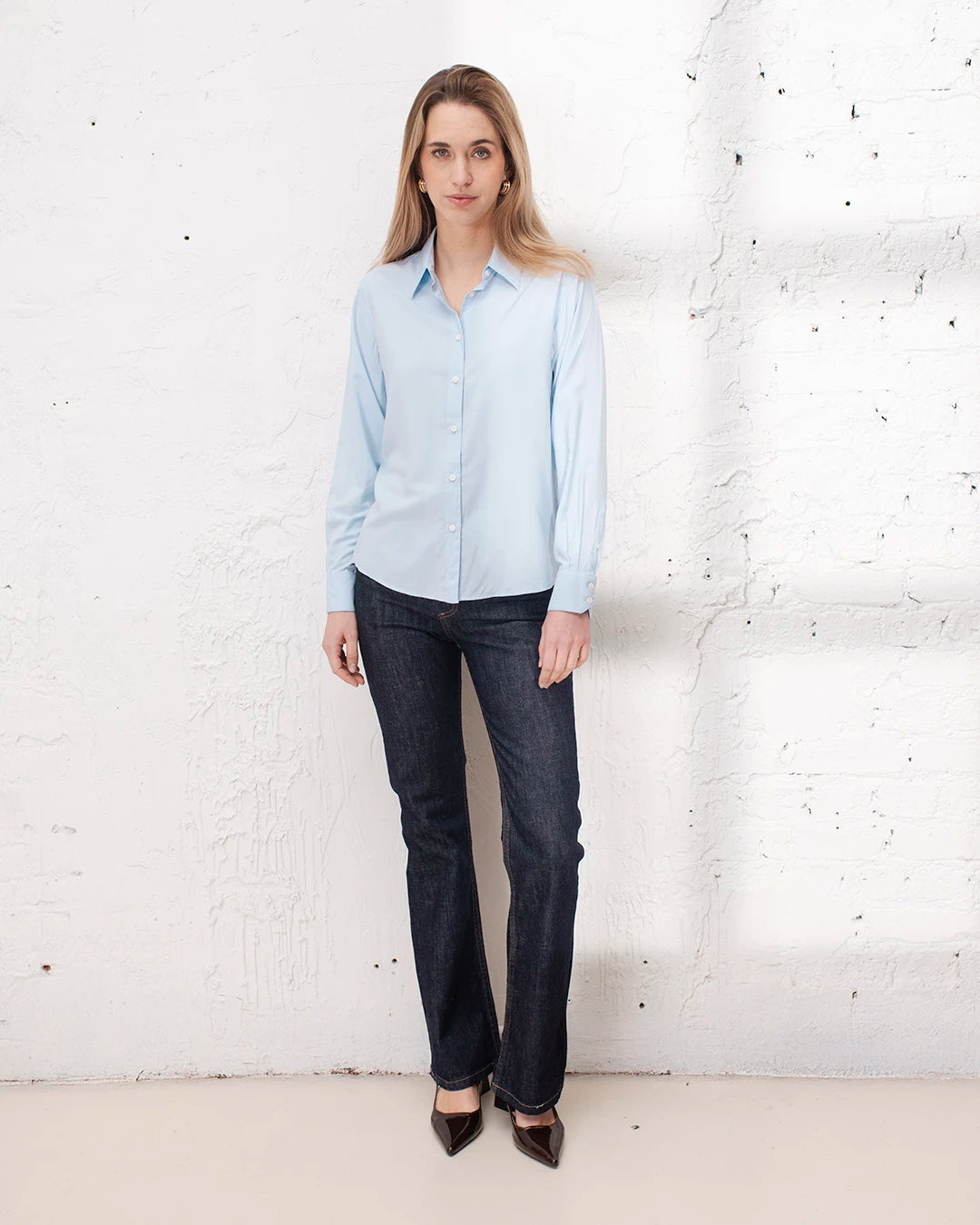 Chemise classique bleue femme, essentiel du dressing professionnel pour le travail.